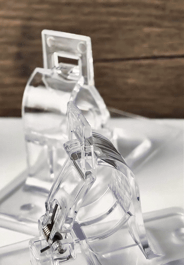 Close-up demonstration of the clear adjustable ClearHold curtain rod holder