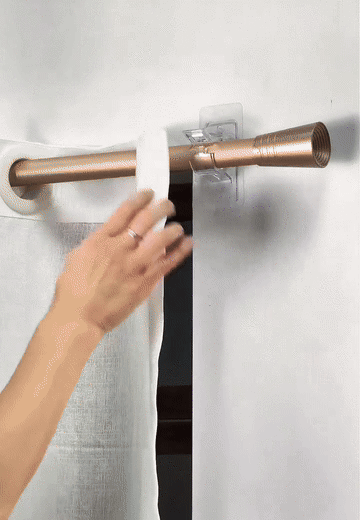 Demonstration of a curtain rod being placed in a ClearHold no-drill holder